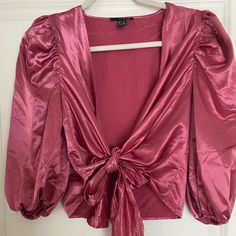 Plunging V-Neck, Satin, Front Tie Blouse. Bnwt! Features 3/4 Length Puff Sleeves. Super Cute Just Didn’t Care For The Color On Me. Glamorous V-neck Tops For Date Night, V-neck Padded Blouse For Brunch, Glamorous Pink V-neck Blouse, Glamorous V-neck Tops For Spring, Trendy V-neck Blouse For Party, Feminine V-neck Party Top, Padded V-neck Blouse For Brunch, Glamorous V-neck Blouse For Summer, Glamorous V-neck Summer Blouse