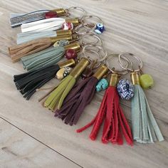 a bunch of different colored tassels laying on top of a wooden floor