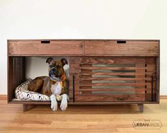 a dog laying on top of a bed under a wooden cabinet