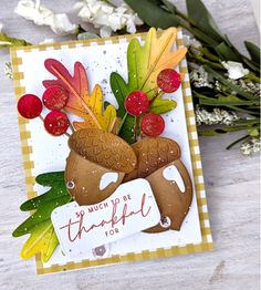 a close up of a card with flowers and leaves