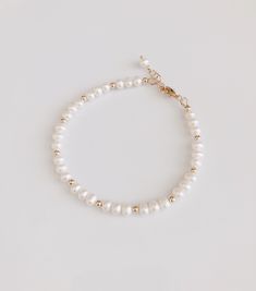 "* DETAILS * - Freshwater Pearl Potato Shape White Pearls Size Approx.5mm - 14k Gold Filled Beads 3mm - All components are 14k Gold Filled 👉🏻 Fits wrist size from 6\" to 7.5\" * CARE TIPS * ⭐️TO PREVENT TARNISH:Keep your jewellery in airtight plastic bags. It won't tarnish if it isn't exposed to air. The worst place to leave your jewellery is in a steamy bathroom. Wipe with a soft cloth after wearing. - Perfumes: Be sure any perfume or lotions are completely absorbed into skin. - Hair products Classic Single Strand Beaded Bracelet For Gift, Classic Single Strand Beaded Bracelets As Gift, Classic Single Strand Beaded Bracelet As Gift, Dainty White Gold Bracelet With Round Beads, Dainty White Beaded Bracelet For Anniversary, Elegant White Bracelets For Birthday, Elegant White Bracelet For Birthday, Gift Single Strand Round Gold Bracelet, Gift Pearl Bracelet With Gold Round Beads