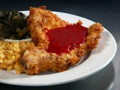 fried chicken, macaroni and cheese with ketchup on a white plate