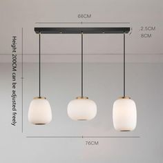 three lights hanging from the ceiling with measurements