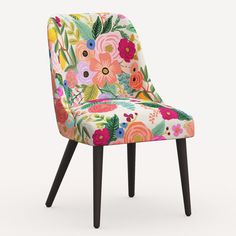 an upholstered chair with colorful flowers and leaves on the back, against a white background