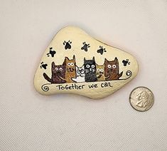 three cats on a rock with the words together we can next to a quarter penny