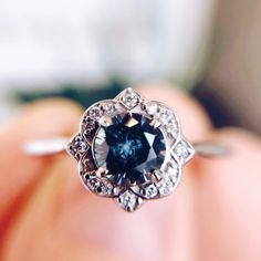 an engagement ring with a blue diamond in the center