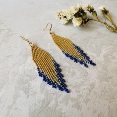 These gold beaded earrings with long fringe are shining accessory for a special event or Christmas party. Made from high-quality Miyuki seed beads and supplied with stainless steel hooks, these festive waterfall earrings are lightweight and comfortable to wear. No doubt, these chic micro bead earrings will be a highlight of any outfit. It will be a great gift for anybody who loves statement seed bead earrings or luxury jewelry. Length: 3.35''/ 8,5 cm  Width: 0.75''/ 1,9 cm Material: Miyuki Round seed beads, stainless steel accessories. 100% top quality handmade earrings The real color of the item may be slightly different from the picture shown on website caused by the brightness of your monitor. If you have special size requirements, please send me a letter about it, as this can be made t Christmas Party Earrings, Gold Beaded Earrings, Waterfall Earrings, Gold Bead Earrings, Stainless Steel Accessories, Long Fringe, Party Earrings, Earrings Long, Christmas Earrings