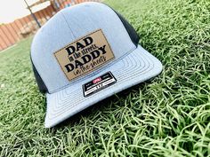 "Embrace the playful side of fatherhood with our 'Dad in the Streets, Daddy in the Sheets' Hat - a cheeky and lighthearted accessory that adds a touch of humor to Dad's wardrobe. This funny hat makes for a unique and entertaining gift for fathers, celebrating their dual role with a wink and a nod. Details: Richardson original 112 trucker; adjustable  Hat is one size fits most. Leatherette patch is engraved with the saying \"Dad in the streets, Daddy in the sheets.\" Care instructions: Do not wash; only spot clean. Please note: As with any handmade item, there may be light imperfections or variations in color. Colors may vary from photos depending on your viewing screen. If you have any additional questions, please message me and I will get back to you quickly! T&A Designs LLC is not respon Father's Day Gift Trucker Hat With Curved Brim, Father's Day Gift Snapback Hat With Curved Brim, Casual Trucker Hat For Father's Day, Flat Bill Hats For Father's Day Gift, Letter Print Hat For Father's Day Gift, Adjustable Hats As Father's Day Gifts, Father's Day Gift Hats With Letter Print, Father's Day Hats With Letter Print, Father's Day Gift Flat Bill Hat