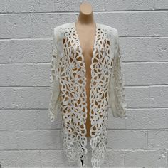 Intricate Eyelet Cut-Outs And A Beaded Finish By Moshita Couture. Tailored In Fit, Shoulder Pads, Excellent Like New Condition. Size 14 Fits Medium Large. Long Sleeve Summer Evening Outerwear, Summer Evening Long Sleeve Outerwear, Spring Embellished Long Sleeve Blazer, Fitted Embellished Spring Cardigan, Spring Fitted Embellished Cardigan, Fitted White Outerwear For Festival, Elegant Long Sleeve Festival Outerwear, Elegant Spring Cardigan With Sequins, Elegant Sequined Cardigan For Spring