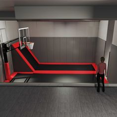 a man standing in front of a basketball hoop on top of a red and black floor