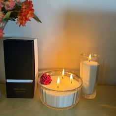 two candles and a box on a table