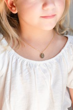 "A cute toddler, baby, or little girl coin disc initial necklace. This adorable initial necklace makes the perfect personalized gift for any girl, any age! They will smile with excitement when they unbox their very own cute initial necklace! It's simple, classic design will be popular and trendy for many years to come. Each shiny gold or silver plated initial disc charm is strung from a sturdy diamond-cut chain. Strong enough to stand up against anything your little one may do! It makes a great Nickel-free Cute Charm Necklaces For Birthday, Cute Personalized Gold Charm Necklace, Cute Nickel-free Round Necklaces, Personalized Cute Charm Necklace For Best Friend, Cute Nickel-free Necklace For Birthday, Cute Gold Charm Necklaces For Personalized Gifts, Cute Gold Charm Necklace For Personalized Gift, Cute Necklace For Mother's Day, Personalized Cute Necklaces