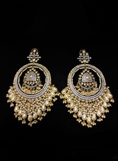 Russu - Amrapali Indian Cluster Pearl Earrings with Kundan stones Amrapalli Indian bridal earrings made with hammered metal and plated with gold. This luxurious Kundan stone stud setting makes this earring jewelry one of a kind. Gorgeous cluster pearls adorn this piece adding grace to this jewelry piece. Mini pearl drops enhance this piece making it perfect to be paired with any of your ethnic wear. Approximate earrings 3.5" Details: Handcrafted Metal: Metal Alloy, Gold Plated Stone: Kundan &amp Festive Temple Jewelry Pearl Earrings With Stone Work, Elegant Metal Chandbali Bridal Earrings, Elegant Chandbali Bridal Earrings In Metal, Elegant Chandbali Metal Chandelier Earrings, Elegant Metal Chandbali Chandelier Earrings, Elegant Chandbali Pearl Earrings With Latkans, Fusion Style Pearl Drop Jewelry For Celebration, Gold Metal Bridal Earrings For Celebration, Gold Bridal Earrings For Celebration