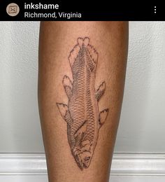 a fish tattoo on the leg of a person