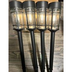 three black metal and glass lantern lights