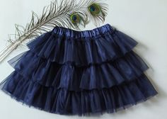 Layered skirt. Material eurofatin. Stretch satin lining. The color is  nave blue. Length 35 cm, waist circum ference 55-60 cm For a girl 6- 8 years A wonderful tutu for your little princess for her birthday, as a gift. SIZE 6T-8T MATERIAL Tulle,  Waistband SHIPPING The average processing time is 1-3 business days. Standard shipping time takes about 21-28 days. Express DHL delivery takes 3-6 days, and UPS time frame is 10-12 days (US). CLEANING AND CARE INSTRUCTIONS Turn the item inside out, select a delicate cycle on the washing machine, and make sure the water temperature is cold and the spin is low. Do not bleach! Choose tumble dry low (Delicate/Gentle cycle) or lay the item flat in its natural shape on a drying rack or hang to dry. Do not iron directly on the design! To remove wrinkles, Blue Tutu Skirt, Tutu Skirt Kids, Uniform Ideas, Tutu Birthday, Blue Tutu, Tutu Party, Puffy Skirt, Fluffy Skirt