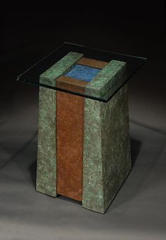 a glass and wood table on a black background