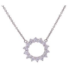 This pre-owned Tiffany & Co. Open Circle Diamond Pendant is crafted in platinum and features 14 diamonds of F color with VS and VVS clarity. The diamonds are set with shared prongs, designed to enhance their brilliance and showcase Tiffany's renowned diamond quality. The pendant measures 9.4mm on the outside and 7.6mm on the inside, offering a delicate yet substantial look. The platinum adds a comfortable weight and enhances the necklace's durability. Condition Report Pre-Owned , Excellent condition, expertly polished and Cleaned.  No scratches, No wear and tear.  Necklace Specifications Brand: Tiffany & Co. Size: Small Hallmarks: Tiffany & Co. , PT 950,  Metal: Platinum Weight: 3.6 G Length: 16.5 Inches Closure: Spring ring Clasp Outside diameter: 9.4 mm Current Retail Price: 4,700 Packag Diamond Circle Pendant, Tiffany Diamond, Circle Pendant Necklace, Circle Diamond, Platinum Engagement Rings, Modern Necklaces, Tiffany And Co, Diamond Rings Bands, Key Pendant