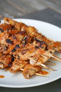 chicken and mushroom skewers on a white plate