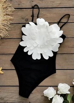 This stunning Big 3D Flower Detail Monokini features an exquisite white flower applique in the front, adding an elegant touch of sophistication and style to the black one-piece. This luxurious swimsuit creates a beautiful silhouette, making it perfect for all your beach-side getaways. Material: Polyester Fiber Swimwear cannot be returned or exchanged. Elegant Black Swimwear For Beach Party, Summer Beach Swimwear With Flower Design, Black Monokini, Beautiful Silhouette, Beach Side, Black One Piece, Flower Detail, Flower Applique, Monokini