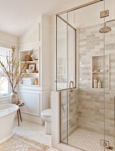 a bath room with a toilet a tub and a window