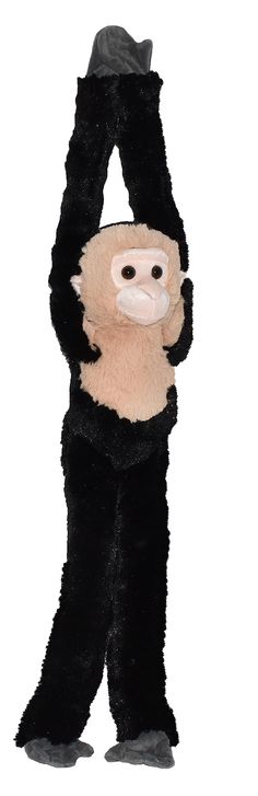 a stuffed monkey is standing with its arms in the air