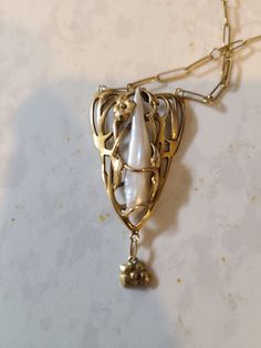 Hello! For sale is an unmarked, pure 14k floral theme and baroque pearl pendant necklace found at an estate sale. It has a Paperclip 14k chain attached, and while neither is marked 14k, acid and electronic testing confirms it is (and is not just plated or filled) Which is an interesting prospect - jewelry was required to be stamped with purity in the u.s. in early 20th century if it were being sold as that purity. I'm guessing this isn't THAT (1903) old, as it's in almost perfect condition, asid Antique White Gold Necklace With Pearl Pendant, Antique Pearl Pendant Necklace For Formal Occasions, Antique Pearl Necklace With Pearl Pendant For Formal Occasions, Formal Hand Forged White Gold Jewelry, Formal Baroque Hallmarked Jewelry, Ornate Baroque Yellow Gold Jewelry, Formal Antique Pearl Drop Necklace, Art Nouveau White Gold Jewelry, Collectible Gold Baroque Jewelry