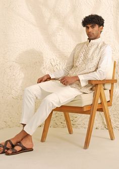 Introducing the sophisticated Ivory and Muted Gold Waistcoat Set. This ensemble features an ivory kurta with a Chinese collar and a concealed placket, paired with a refined waistcoat in muted gold and matching ivory pants. Ideal for puja ceremonies, engagements, Roka functions, or receptions, this set epitomizes elegance and style. Composition : Dupion Silk Care: Dry Clean Only and Vacuum Storage This product can be customized for sleeves, length and colour Delivery : 4-6 weeks as the product is hand crafted. Check Size Guide or choose MySize for free customisation (All Sizes above XL can be made at 15% additional cost) For more information and sizes please contact fabiliciousfashion@gmail.com or visit our Copenhagen studio. About the Designer : Shreyansh, a distinguished designer label sp Formal Cream Nehru Jacket With Chikankari Embroidery, Elegant Cream Nehru Jacket With Chikankari Embroidery, Elegant White Nehru Jacket With Chikankari Embroidery, Elegant White Bandhgala Straight Kurta, Elegant Beige Bandhgala For Designer Wear, White Classic Nehru Jacket For Semi-formal Occasions, Classic White Nehru Jacket For Semi-formal Occasions, White Elegant Nehru Jacket For Designer Wear, Elegant White Nehru Jacket For Designer Wear