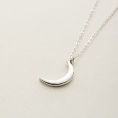 The necklace with the image of a delicate new moon is You can wear it simply and without hesitation.  The moon motif of thes necklace is somewhat mysterious and gentle. Matching earrings are also available. Anyway, I recommend this jewelry as a cute and versatile bracelet! "Sterling Silver" Sterling silver(sv925)  Made in Japan.  Care Guide To make your delicate jewelry last for a long time, please follow these guidelines: Avoid putting on or taking off clothes while wearing jewelry, as it can c Dainty Moon-shaped Jewelry For Everyday, Minimalist Moon Phase Pendant Necklace, Sterling Silver Moon Phase Charm Necklaces, Elegant Moon-shaped Necklace With Delicate Chain, Elegant Moon Shape Clavicle Chain Necklace, Everyday Half Moon Phase Necklace, Celestial Half Moon Necklace For Everyday, Celestial Crescent Necklace For Everyday, Everyday Celestial Half Moon Necklace