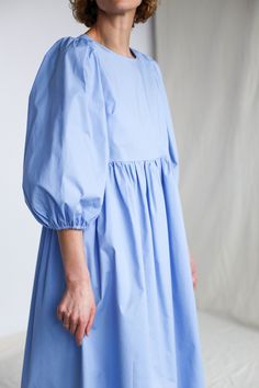 "Puffy sleeve cotton dress in sky blue color. Perfect for any occasion or to wear every day. - Handmade in our studio from 97% cotton 3% spandex - Relaxed fit - Crew neckline - Half-length puffed sleeves - Side slip pockets - Full A-line skirt - Straight, midi hem FABRIC&CARE Cotton Hand wash or gently machine washable 30C, hang dry recommended, iron on reverse. SIZE&FIT Simona is wearing XS size and is 172 cm/5'8\" tall. SIZE XXS *BODY: Bust: fits bust around 32\"-33\"/ 82-84 cm Waist: Cotton Mini Dress With Puff Gathered Sleeves, Summer Cotton Mini Dress With Gathered Sleeves, Cotton Knee-length Mini Dress With Gathered Sleeves, Knee-length Cotton Mini Dress With Gathered Sleeves, Cotton Day Dresses With Gathered Sleeves, Blue Cotton Relaxed Fit Dress, Cotton Daywear Dress With Gathered Sleeves, Blue Puff Sleeve Dress With Gathered Sleeves For Spring, Cotton Puff Sleeve Long Sleeve Dress For Daywear