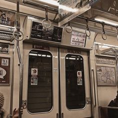 the inside of a subway car with several doors and signs on it's sides