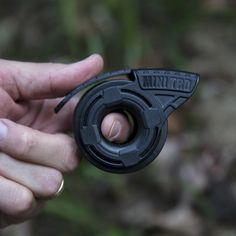 a person holding a black object in their hand