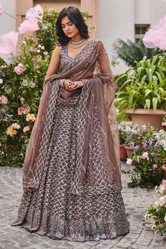 Greyish brown organza embroidered lehenga in mirror and thread work. Paired with embroidered choli and dupatta. Comes with can can.
Component: 4
Pattern: Hand embroidered
Type Of Work: Thread work, Mirror work
Neckline: Round
Sleeve Type: Sleeveless
Fabric: Organza
Color: Brown
Other Details: 
Scallop dupatta
12 Kali lehenga
Occasion: Wedding,Reception - Aza Fashions Brown Dupatta With Resham Embroidery For Navratri, Festive Brown Lehenga With Traditional Drape, Brown Lehenga With Dupatta For Wedding, Festive Brown Lehenga With Dupatta, Brown Wedding Lehenga With Traditional Drape, Anarkali Style Brown Lehenga With Zari Work, Brown Anarkali Lehenga With Zari Work, Bollywood Style Brown Lehenga With Pallu, Brown Bollywood Lehenga With Pallu