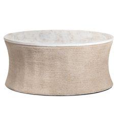 a round table with a white marble top and beige linen covering on the bottom,