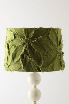 a table lamp with green fabric on it