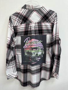 "Show off some Bronco Love in this one-of-a-kind flannel! Women's XL Sonoma upcycled flannel. Grey old school Ford Bronco tee sewn on back. Size: Women's XL Brand: Sonoma Chest: 24\" armpit to armpit Arm Length: 24\" shoulder to hem Back Length: 32\" top of collar to hem Color: Cream and black plaid with burgundy  Material: cotton All clothing is pre-washed & comes from a smoke-free home. Wash gentle cycle, cold water  Tumble dry low Don't iron over graphic tee Please check measurements, sizing Trendy Flannel Long Sleeve Shirt, Trendy Plaid Cotton Flannel Shirt, Long Sleeve Flannel Top With Graphic Print, Trendy Long Sleeve Flannel Tops, Casual Flannel Shirt With Graphic Print, Plaid Flannel Tops With Graphic Print, Plaid Graphic Print Long Sleeve Shirt, Fall Flannel Top With Graphic Print, Fall Flannel Shirt With Graphic Print