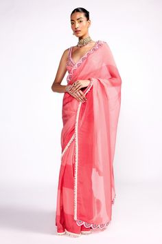 Pink color block saree, highlighted with floral embroidered and pearl encrusted border. Paired with a floral embroidered blouse. Comes along with a petticoat.
Components: 3
Pattern: Embroidered Blouse
Type Of Work: Floral, Sequins, Cutdana
Neckline: V Neck
Sleeve Type: Sleeveless
Fabric: Organza, Georgette, Lining: Satin
Color: Pink
Other Details: 

Model height: 5ft 8 inches, wearing size S
Note: Hair accessory worn by the model is not for sale
Occasion: Sangeet - Aza Fashions Designer Wear Pre-draped Saree With Zari Work, Summer Semi-stitched Pre-draped Saree For Designer Wear, Elegant Summer Pre-draped Saree With Dupatta, Summer Designer Chanderi Saree, Traditional Gota Work Pre-draped Saree, Pre-draped Saree For Designer Wear At Eid, Cotton Silk Pre-draped Saree With Mirror Work, Summer Saree With Mirror Work, Cotton Silk Pre-draped Saree With Mirror Work For Reception