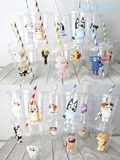 the cups have cartoon characters on them and are lined up with paper drinking straws