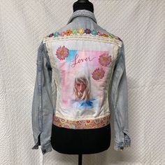 a denim jacket with an image of a woman on it