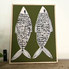 two fish are shown in black and white on a green background