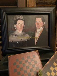 an old portrait of two people is on display