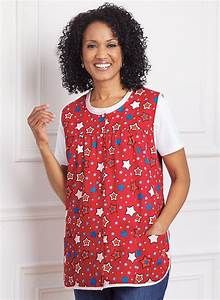 a woman standing in front of a white wall wearing a red top with stars on it