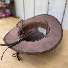 Brown Leather Brimmed Fedora, Brown Leather Fedora For Rodeo, Rustic Leather Fedora For Western-themed Events, Rustic Leather Hat For Western-themed Events, Western Leather Hat In Distressed Brown, Western Hats With Leather Lining And Flat Brim, Western Distressed Brown Leather Hats, Wide Brim Leather Fedora For Western-themed Events, Leather Wide Brim Fedora For Western-themed Events