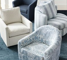 four chairs in different colors and patterns on a blue carpet