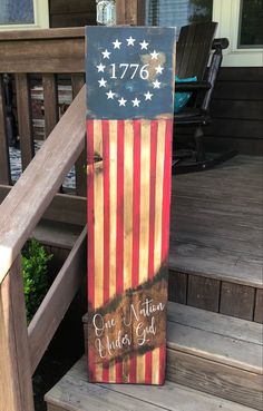 a wooden sign with an american flag painted on it