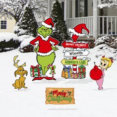 the grinch christmas yard signs are in front of a house with snow on it