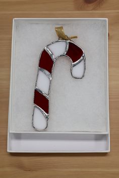 a red and white candy cane in a box