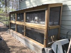 an outside view of a house with a chicken cage on the front and side of it