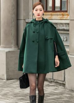 "This Wool cape is a gorgeous clothing with hood, design with hip pockets. This winter cape is made from soft wool fabric,the green wool cape is completely lined in polyester with fabulous flap detailing on the front, shoulders, pockets and back. This is a women's hooded cape you will wear forever. The stylish design will gives a retro feeling and keep you warm in winter days. Put it on, you will be the focus of everyone's attention. Detail * The coat is the perfect gift for everyone. This beaut Oversized Hooded Cape For Cold Weather, Oversized Solid Color Cape Outerwear, Oversized Cold Weather Cape, Oversized Green Hooded Jacket With Pockets, Casual Hooded Winter Cape, Green Hooded Jacket With Pockets For Fall, Green Hooded Outerwear For Fall, Oversized Hooded Cape For Outdoor, Hooded Solid Pea Coat With Pockets