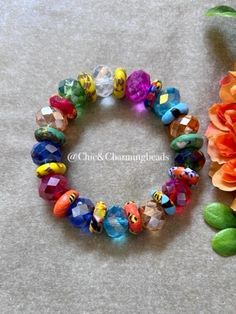 the bracelet is decorated with colorful beads and flowers